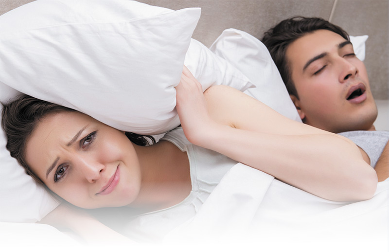 A woman unable to sleep with her husband snoring next to her